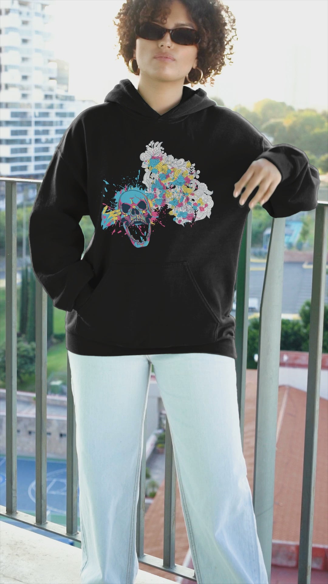 Color Splash Floral Skull Hoodie featuring a bold skull graphic surrounded by vibrant, colorful flowers, blending edgy design with natural beauty for a unique, eye-catching style.